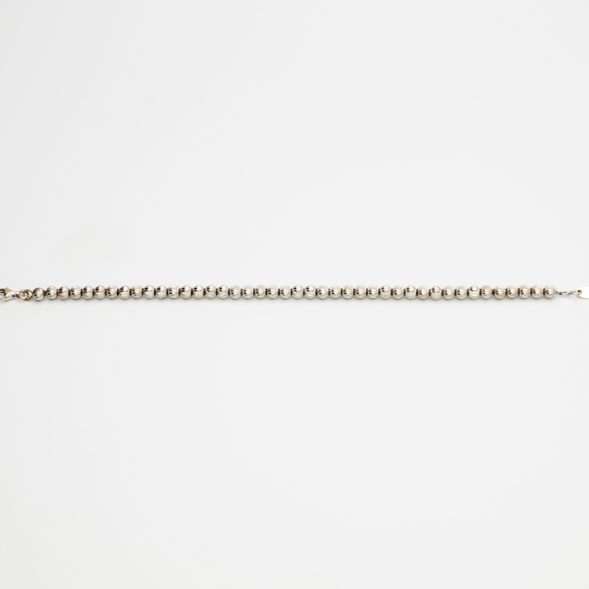 14K white gold ball bracelet with textured beads, laid flat, made in Italy, on white background