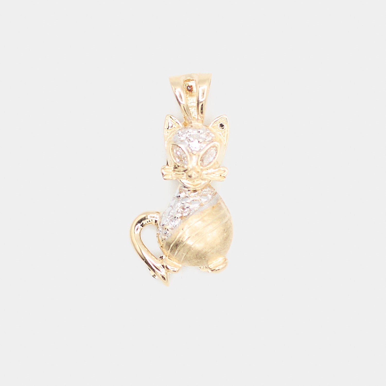 Close-up front view of a pre-owned 14K yellow gold cat charm featuring white stone accents on the face and back, with textured engraved fur detail.