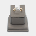 Pre-owned 14K yellow gold engagement ring with three emerald cut diamonds in white gold prong settings, shown front-facing on a display stand. Size 9.5.