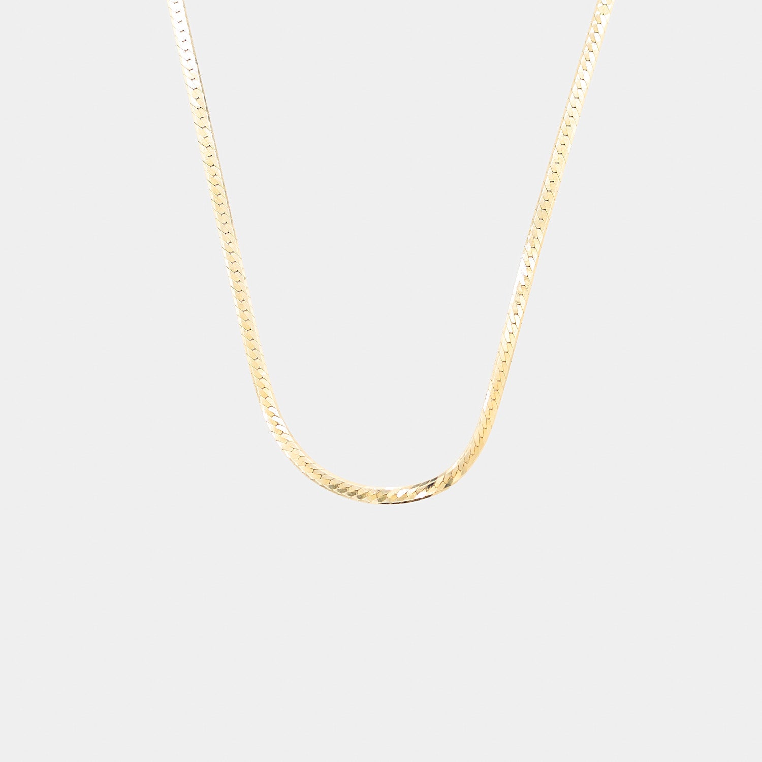 Close-up of a 14K yellow gold herringbone chain showcasing the sleek V-shaped links and polished finish, weighing 4.82 grams.