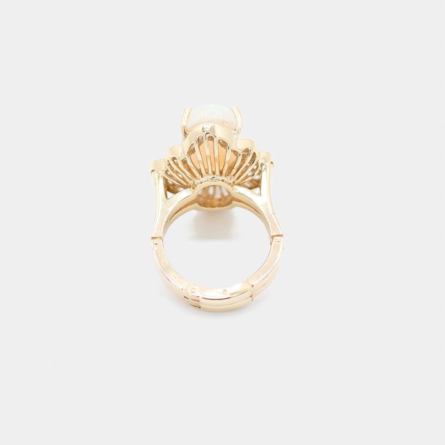 Back view of a pre-owned 14K yellow gold opal ring showing the open fan style gallery beneath the stone, weighing 11.86 grams.