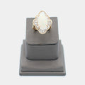 Pre-owned 14K yellow gold opal ring with a baguette diamond halo, shown front-facing on a display stand. Size 6.5.