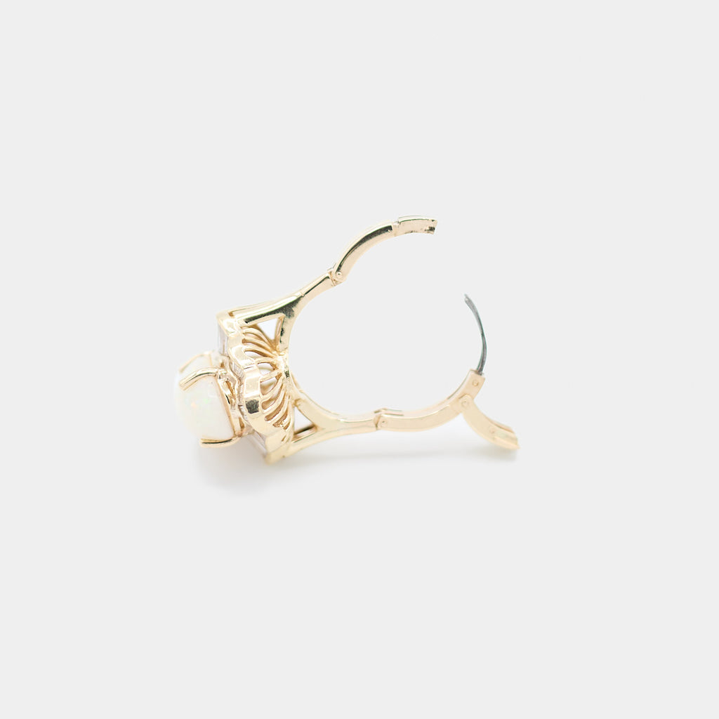 Side view of a pre-owned 14K yellow gold opal ring with the hinged adjustable band open, showing how the ring expands for sizing.