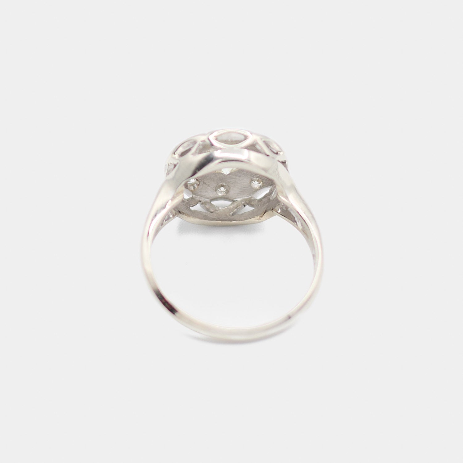 Back view of a pre-owned 14K white gold Art Deco diamond ring showing the open gallery structure and diamond prong settings from underneath.