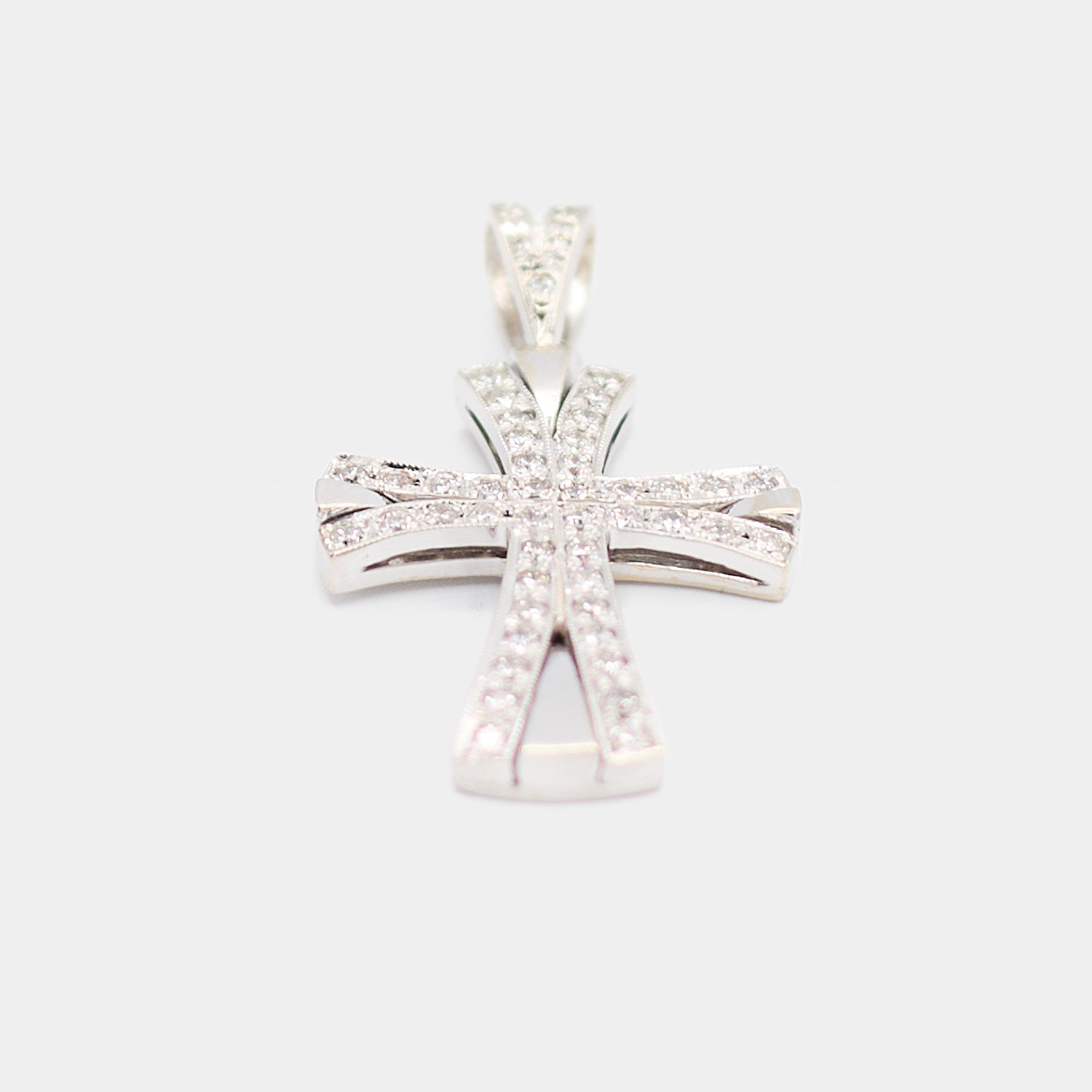Angled view of a pre-owned 14K white gold diamond cross pendant showing the depth of the flared arms and beveled edges.