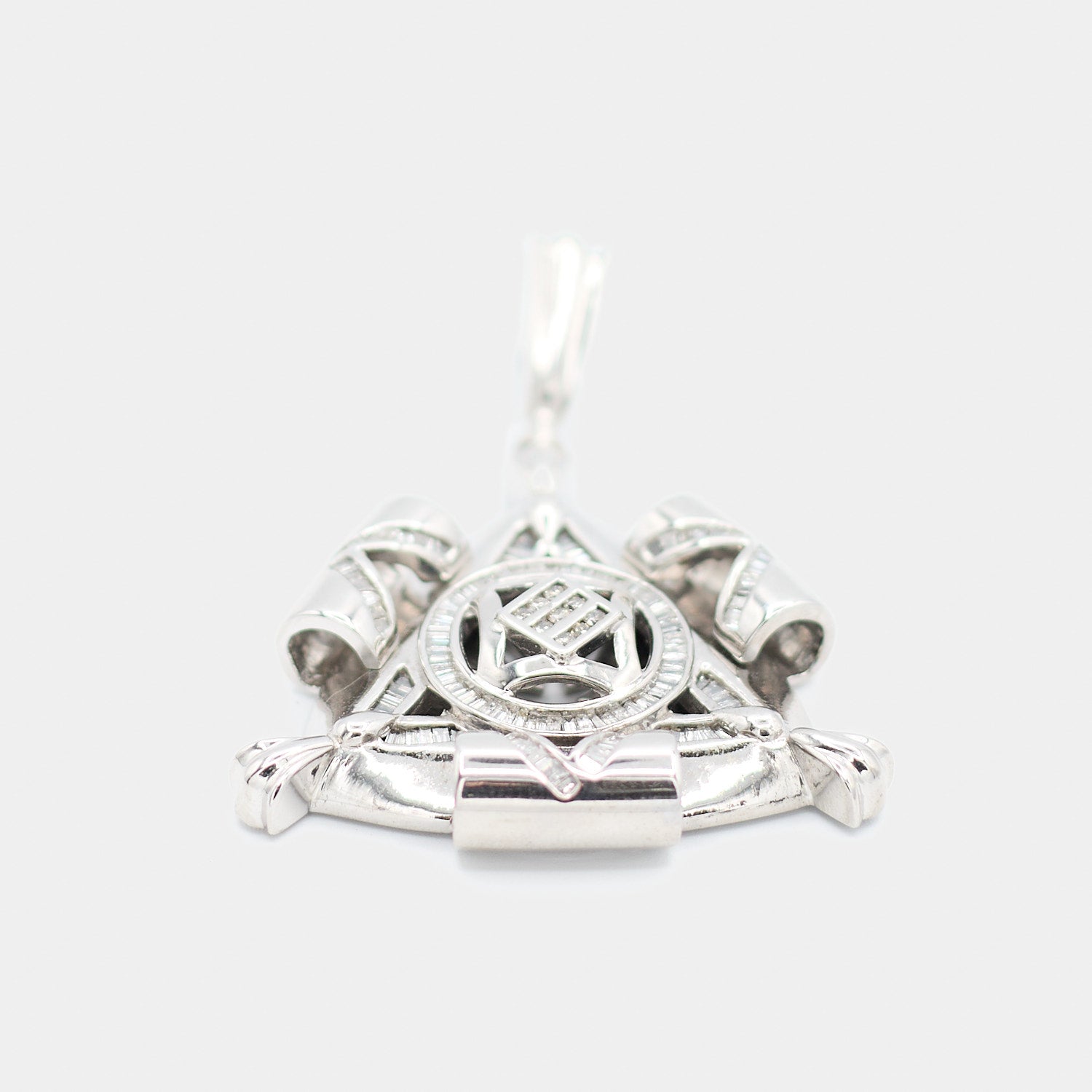 Detailed close-up of a pre-owned 14K white gold Freemason pendant showing baguette-cut diamonds, crossed emblem design, and center diamond cluster set in a lattice pattern.