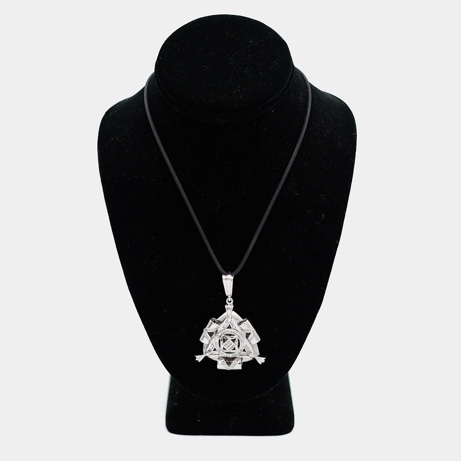 Pre-owned 14K white gold Freemason pendant with diamonds, shown on a black cord necklace against a display bust. The triangular pendant features baguette-cut diamonds and a center cluster of round diamonds. Pendant measures 2.5 inches.
