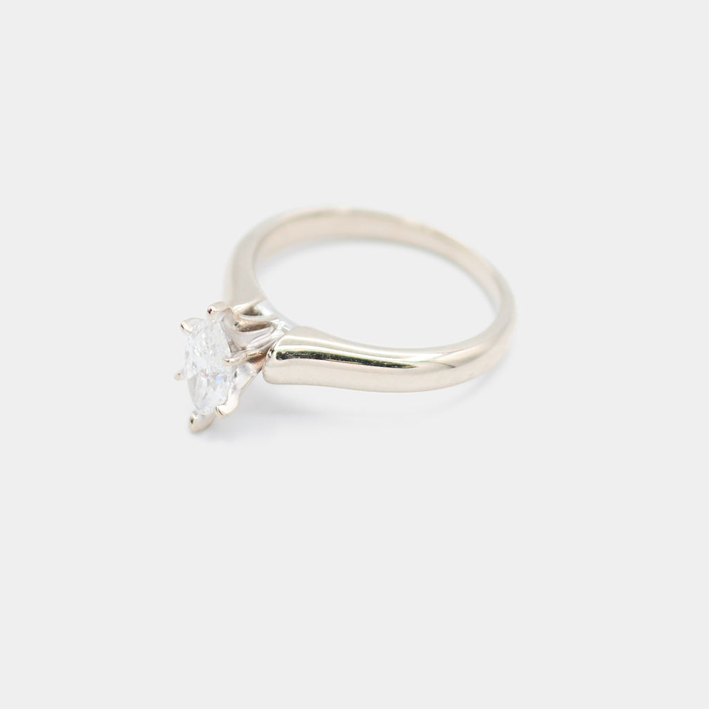 Angled 3/4 view of a pre-owned 14K white gold engagement ring showing the marquise diamond and prong setting detail.