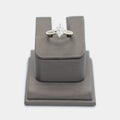Pre-owned 14K white gold engagement ring with a marquise cut diamond in a six prong setting, shown front-facing on a display stand. Size 5.5.