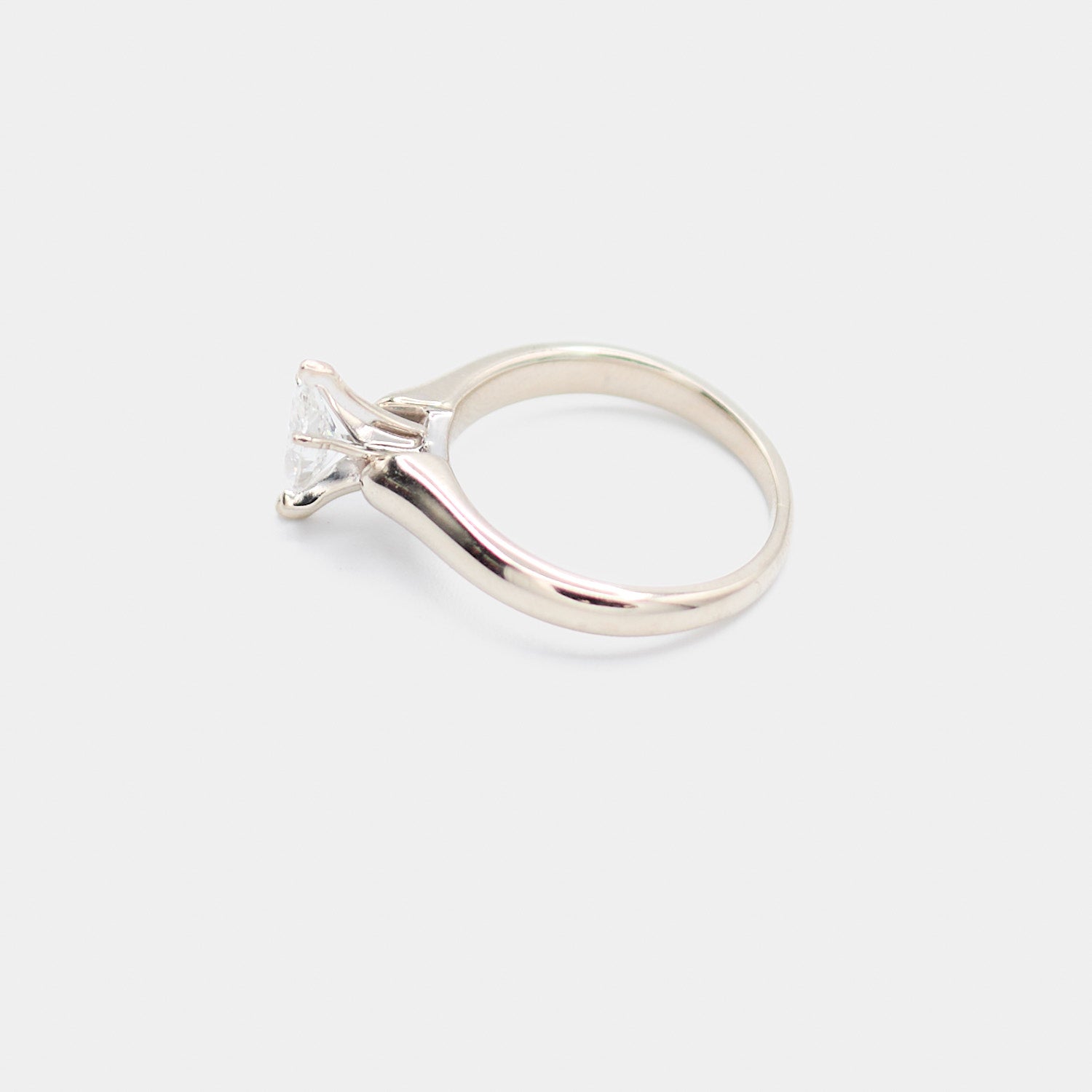 Side profile of a pre-owned 14K white gold engagement ring showing the polished band and marquise diamond setting.