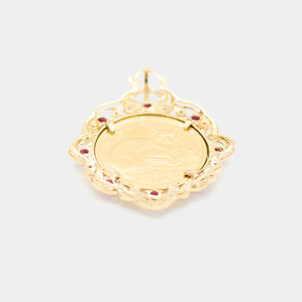 Back view of a pre-owned 18K yellow gold coin pendant showing the reverse side of the 24K gold coin featuring a cat design and "1 Crown" engraving.