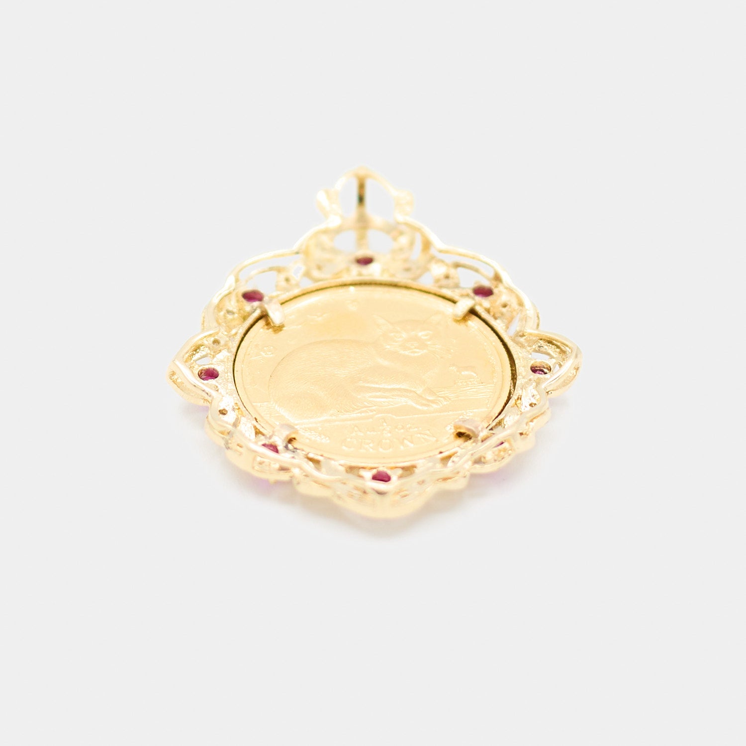 Back view of a pre-owned 18K yellow gold coin pendant showing the reverse side of the 24K gold coin featuring a cat design and "1 Crown" engraving.