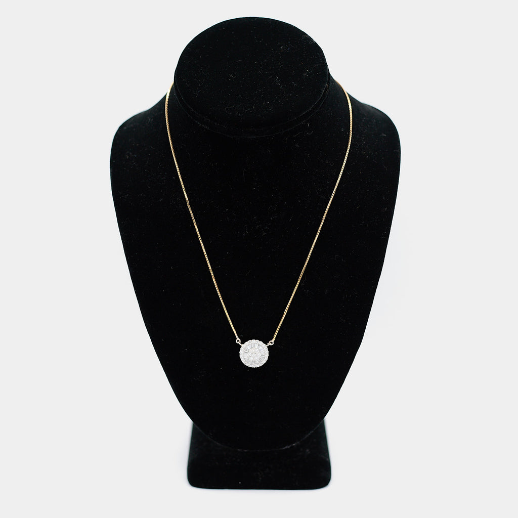 Pre-owned 18K yellow gold box chain necklace with a white gold diamond pendant, featuring round and tapered baguette diamonds in a circular halo design, shown on a display bust. 18 inch chain.