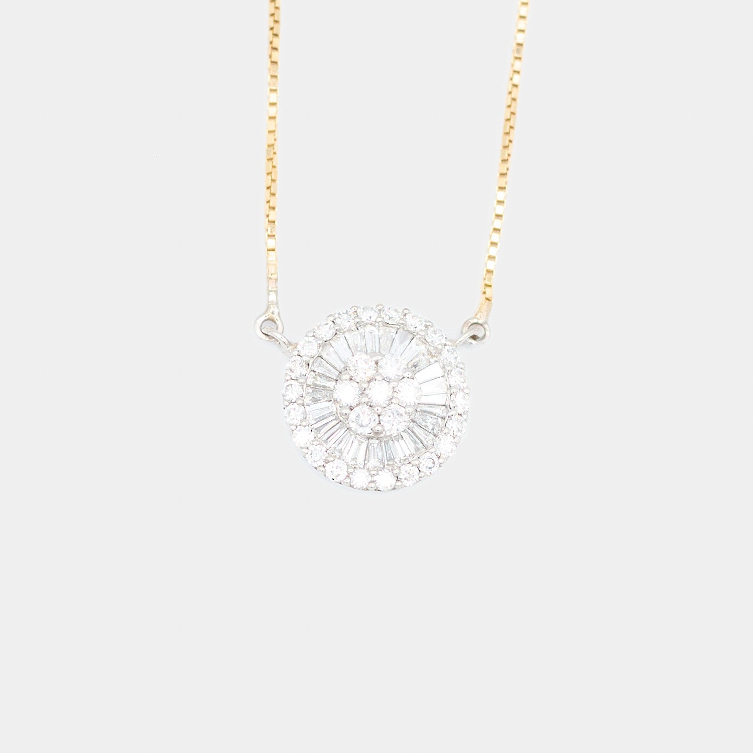 Close-up of a pre-owned 18K white gold diamond pendant showing a center cluster of round diamonds surrounded by tapered baguette diamonds and an outer halo of round diamonds, totaling 2.45 carats.
