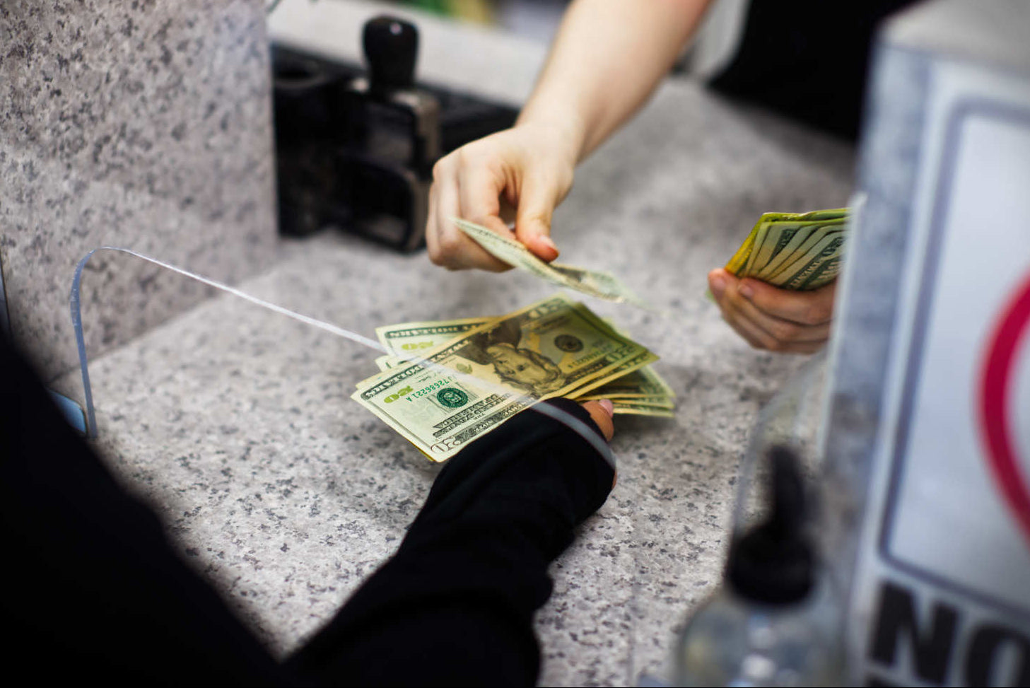 BG Loan and Jewelry handing a customer loan for jewelry