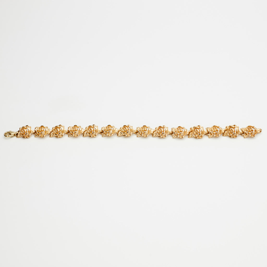 14K Gold Flower Link Bracelet on white background, verified by B.G. Loan & Jewelry