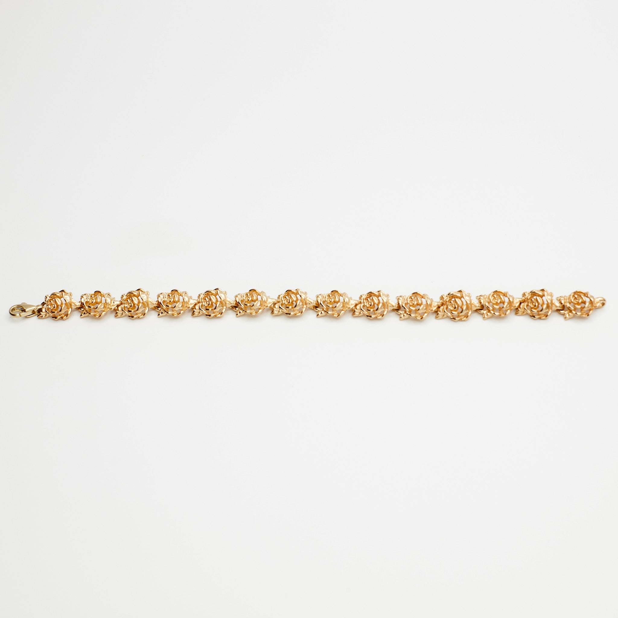 14K Gold Flower Link Bracelet on white background, verified by B.G. Loan & Jewelry