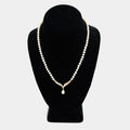 Pre-owned pearl necklace with a 10K gold diamond centerpiece and dangling pearl drop, shown on a display bust. Necklace measures 18 inches.