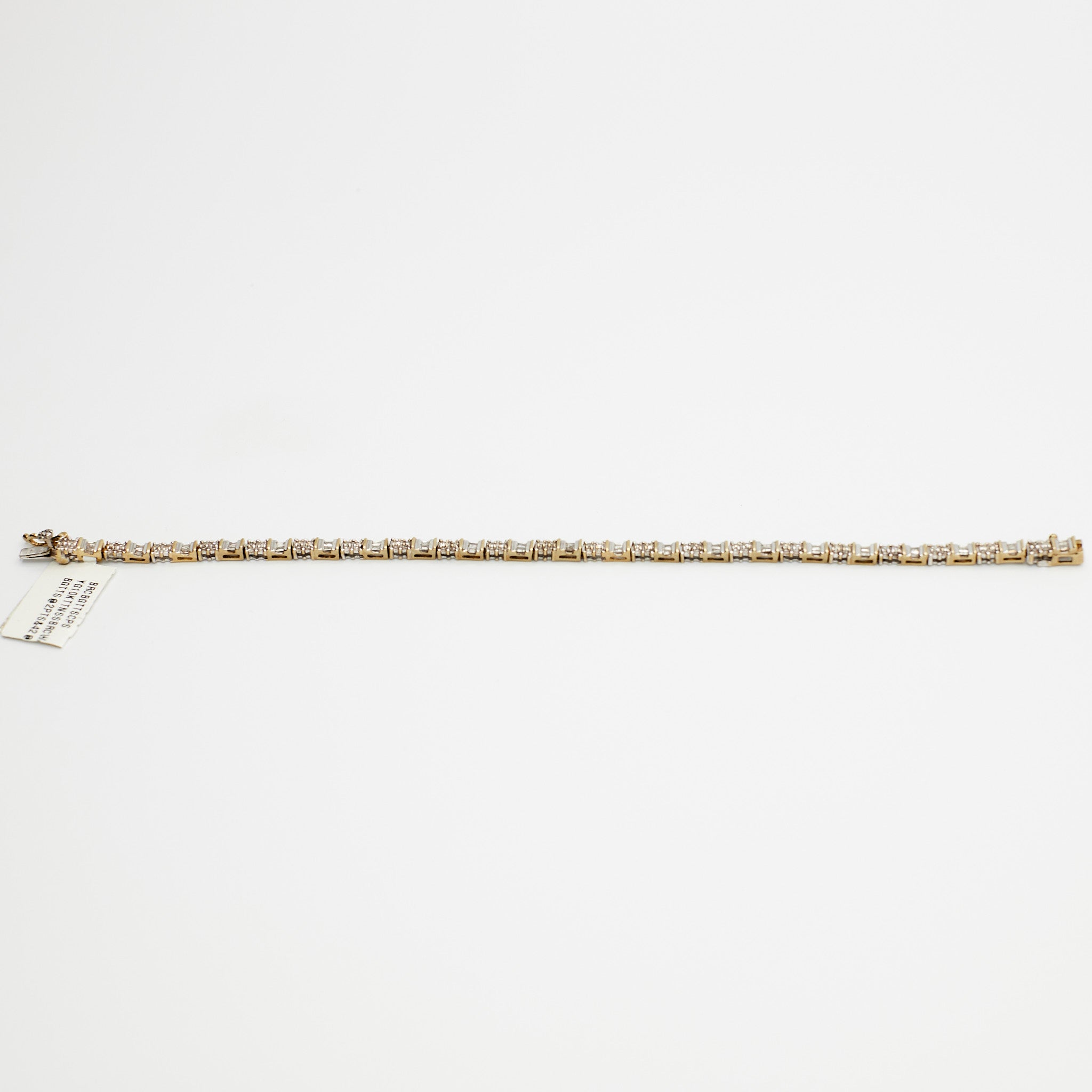 Close-up view of the 10K Dual Tone diamond tennis bracelet, laid flat, emphasizing the setting and 7.99 gram weight.