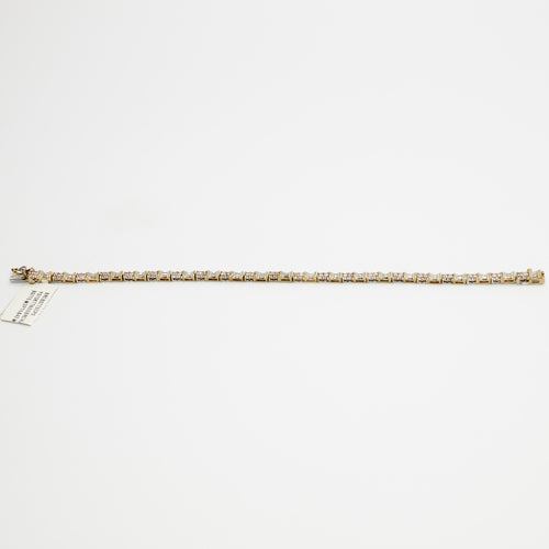 Close-up view of the 10K Dual Tone diamond tennis bracelet, laid flat, emphasizing the setting and 7.99 gram weight.
