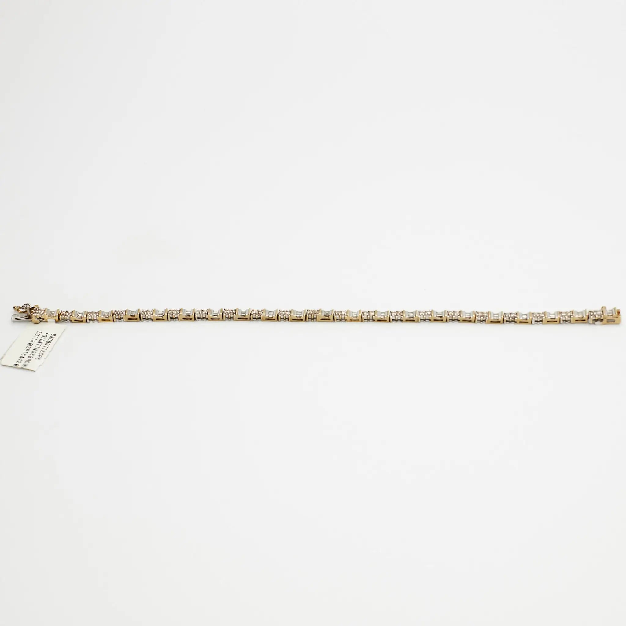 Close-up view of the 10K Dual Tone diamond tennis bracelet, laid flat, emphasizing the setting and 7.99 gram weight.