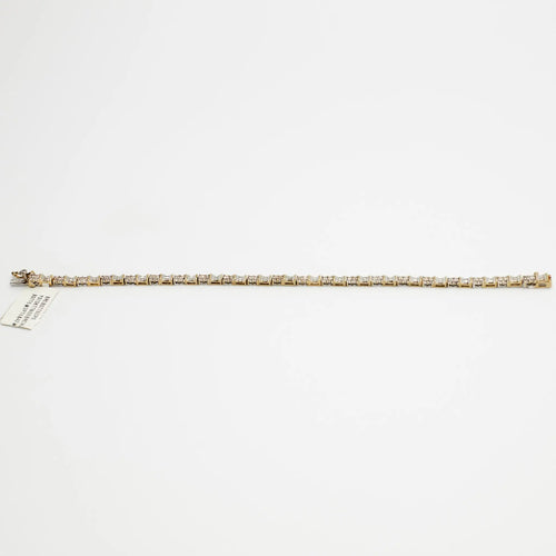 Close-up view of the 10K Dual Tone diamond tennis bracelet, laid flat, emphasizing the setting and 7.99 gram weight.