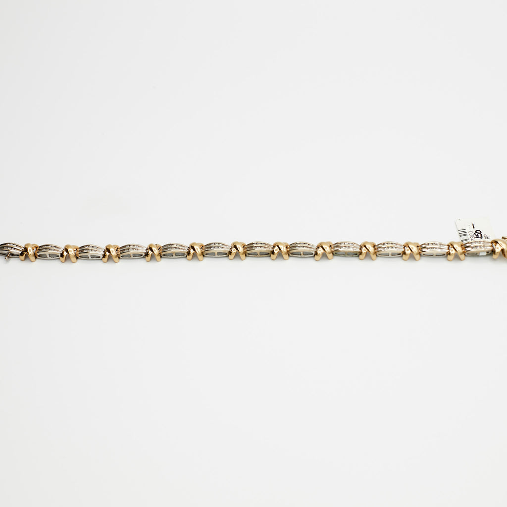 Close-up view of the 10K Dual Tone 'X' link diamond bracelet, laid flat, showcasing the interlocking gold links and 13.63 gram weight.