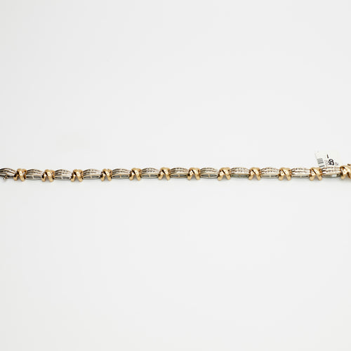 Close-up view of the 10K Dual Tone 'X' link diamond bracelet, laid flat, showcasing the interlocking gold links and 13.63 gram weight.