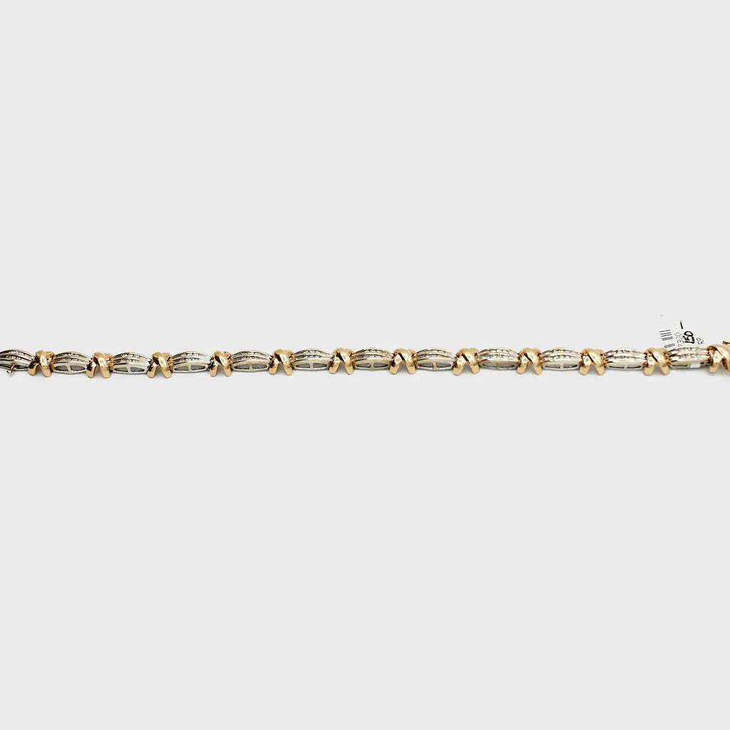 Close-up view of the 10K Dual Tone 'X' link diamond bracelet, laid flat, showcasing the interlocking gold links and 13.63 gram weight.