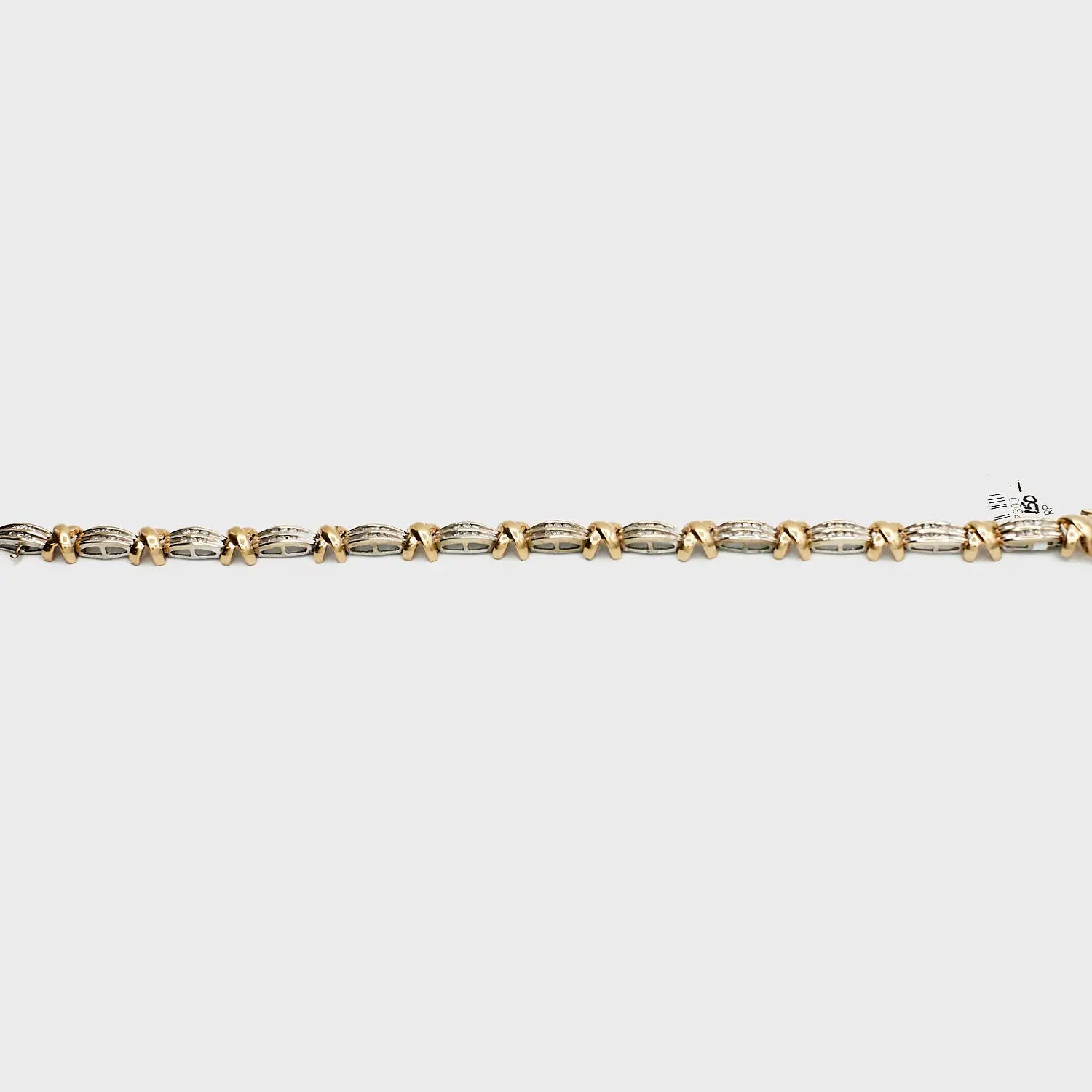 Close-up view of the 10K Dual Tone 'X' link diamond bracelet, laid flat, showcasing the interlocking gold links and 13.63 gram weight.