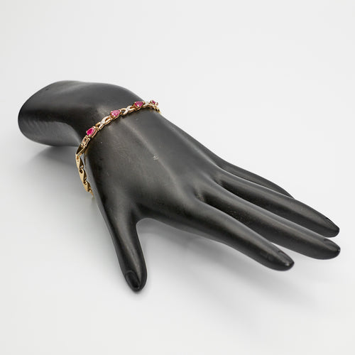 Verified 10K Gold bracelet with alternating red stones and diamonds, 7 inches, styled on a mannequin to show color and fit.