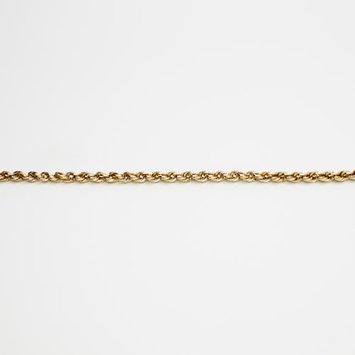 Close-up view of the 10K gold rope chain, laid flat on a white background to show the intricate weave and gold purity.