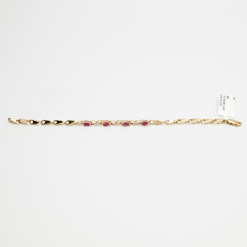 Close-up view of the 10K gold red stone and diamond bracelet, laid flat, showcasing the precise stone settings and 7.71 gram weight.