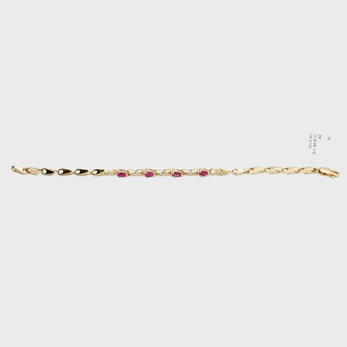 Close-up view of the 10K gold red stone and diamond bracelet, laid flat, showcasing the precise stone settings and 7.71 gram weight.