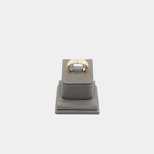 Verified pre-owned 10K yellow gold ring, size 10.25, featuring a brilliant .07 carat round cut diamond on a grey display stand.