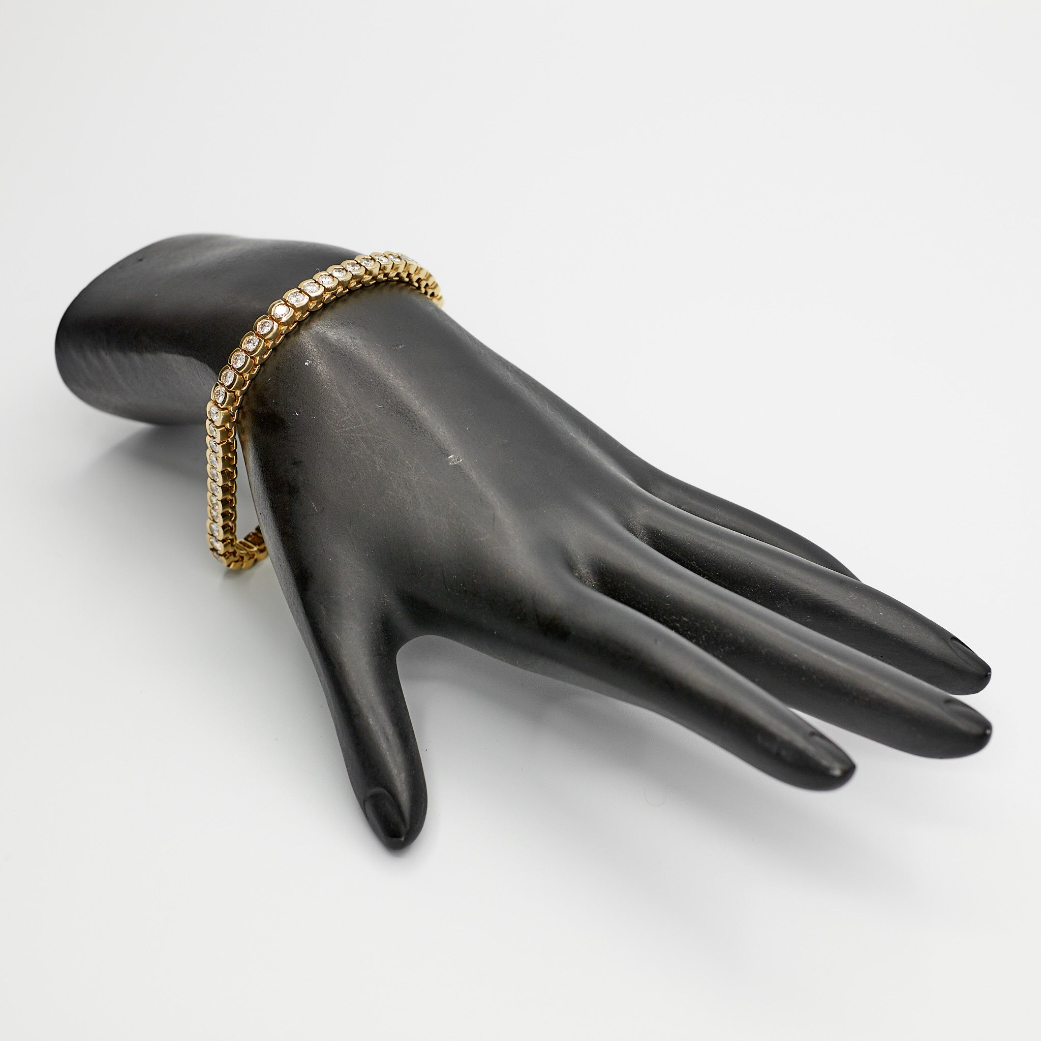 Verified 14K gold diamond tennis bracelet with over 5.2 carats of diamonds, pictured on mannequin.