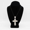 Verified pre-owned 14K white gold large cross pendant, featuring over 3 carats of round and baguette diamonds, displayed on a black mannequin for scale.