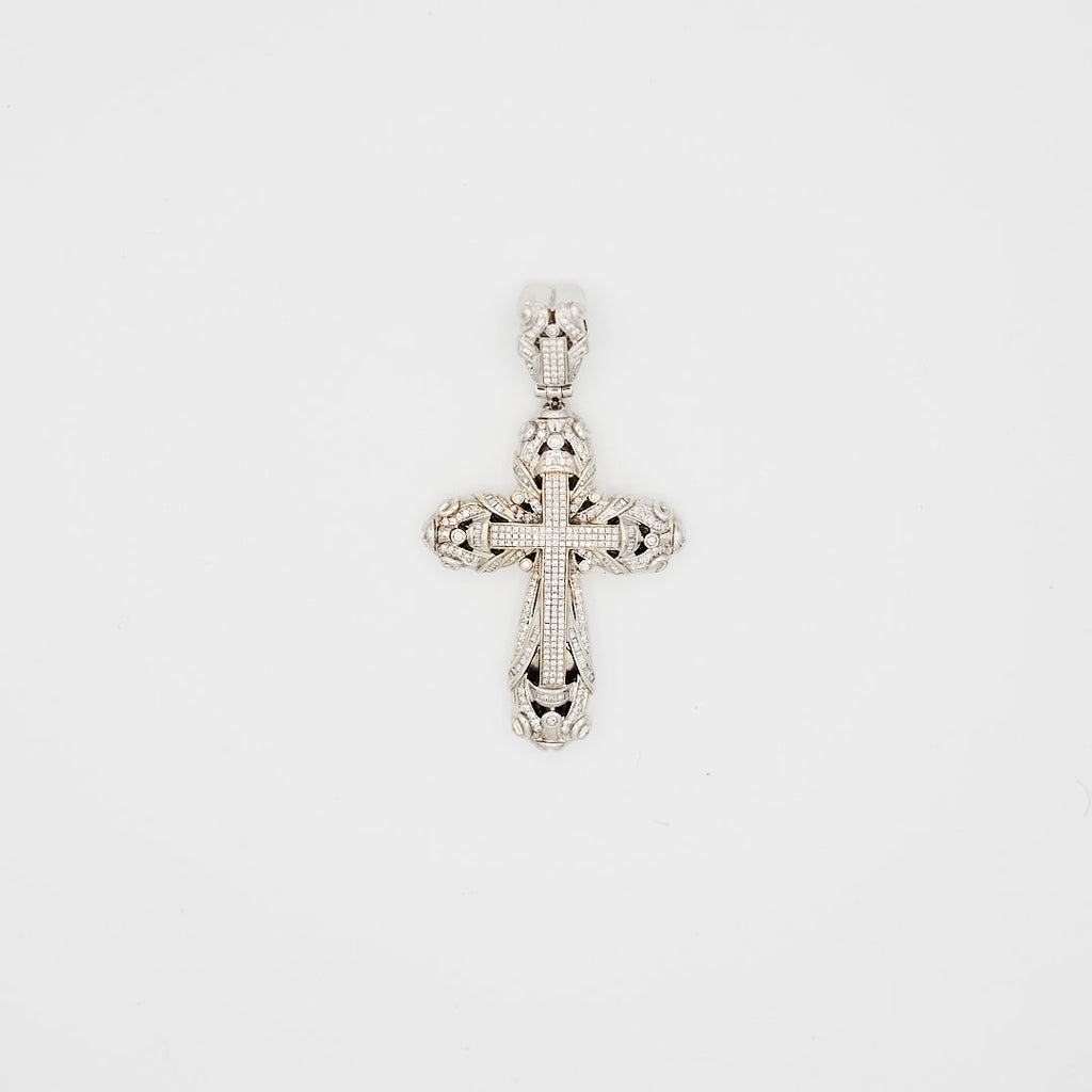 Close-up view of the 14K white gold cross pendant, laid flat, showcasing 3.09 carats of round and baguette cut diamonds and 45.56 gram weight.