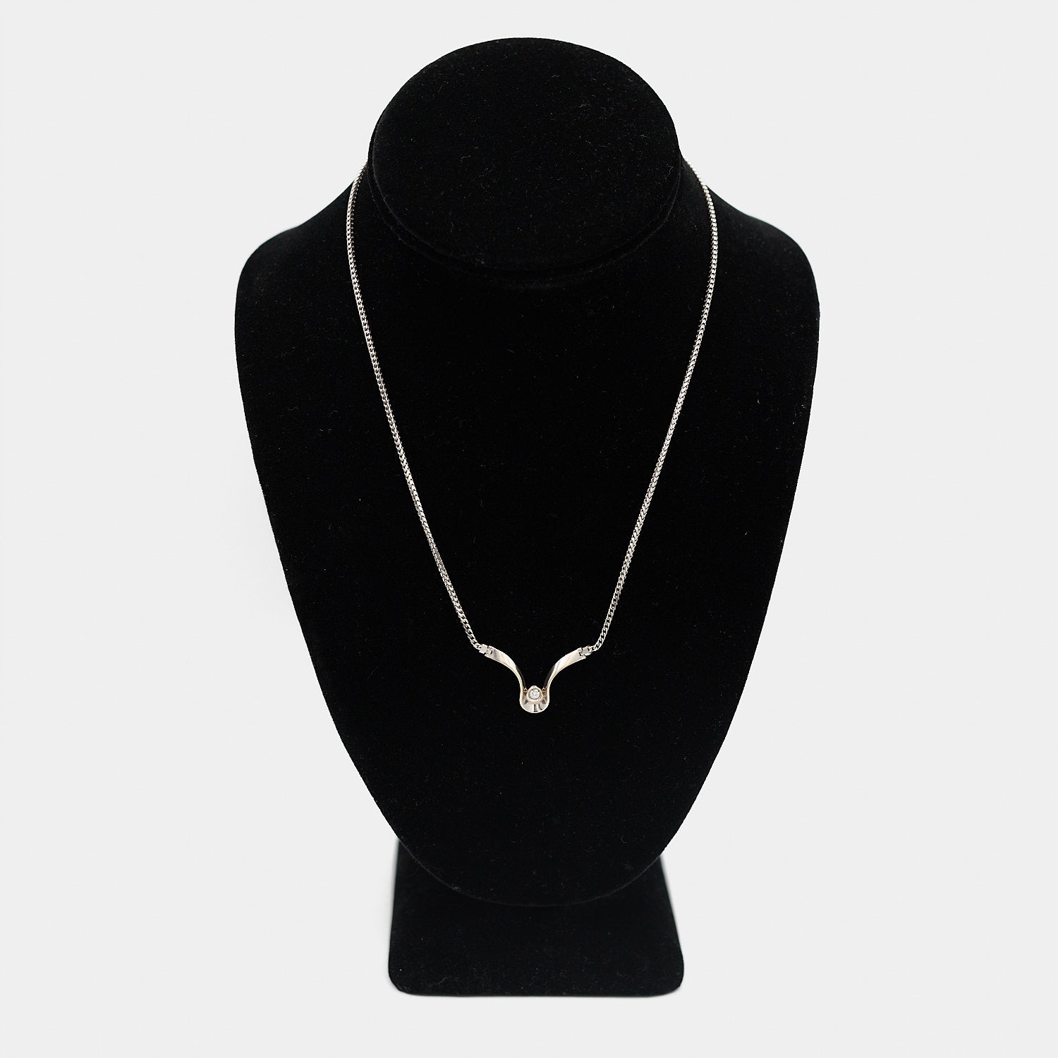 Verified pre-owned 14K white gold necklace with a round-cut diamond pendant, 17.25 inches long, displayed on a black mannequin for scale.