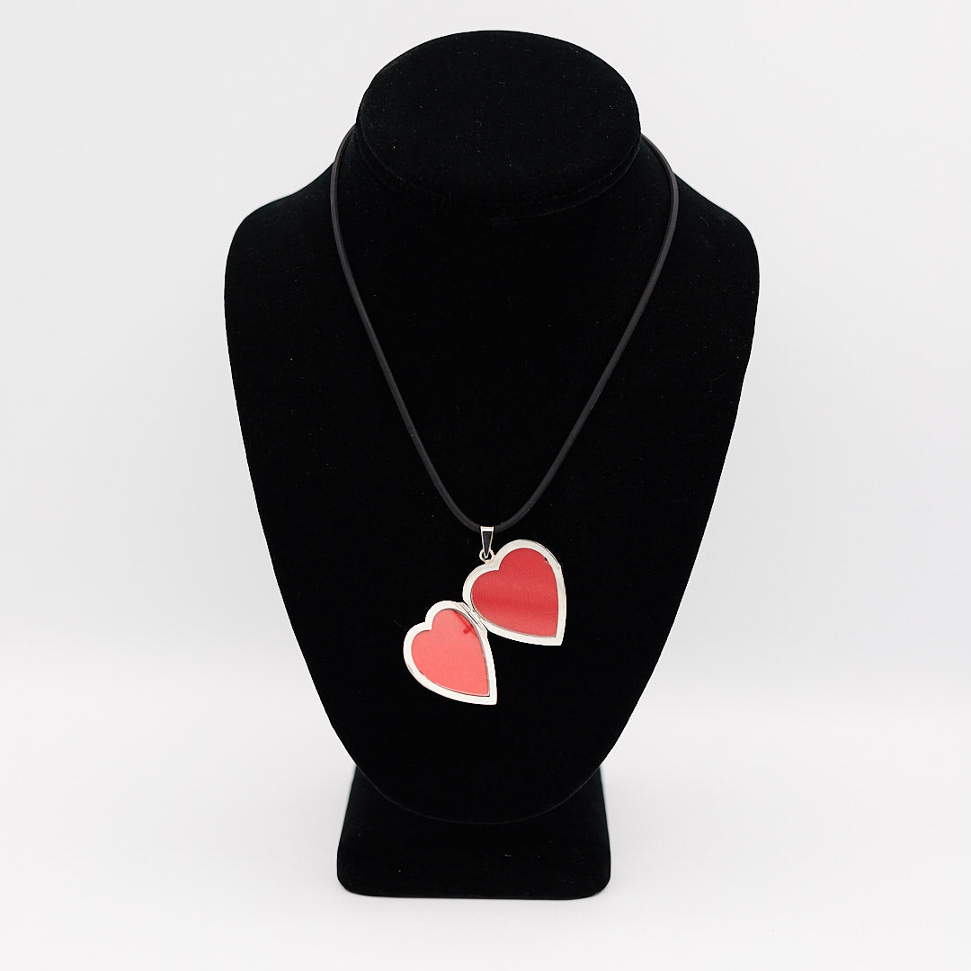 Verified 14K white gold heart photo locket, opened to show the two interior red spaces for holding cherished photographs.
