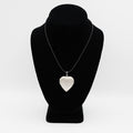 Verified pre-owned 14K white gold heart photo locket pendant, 1.625 inches long, displayed closed on a black mannequin for scale.