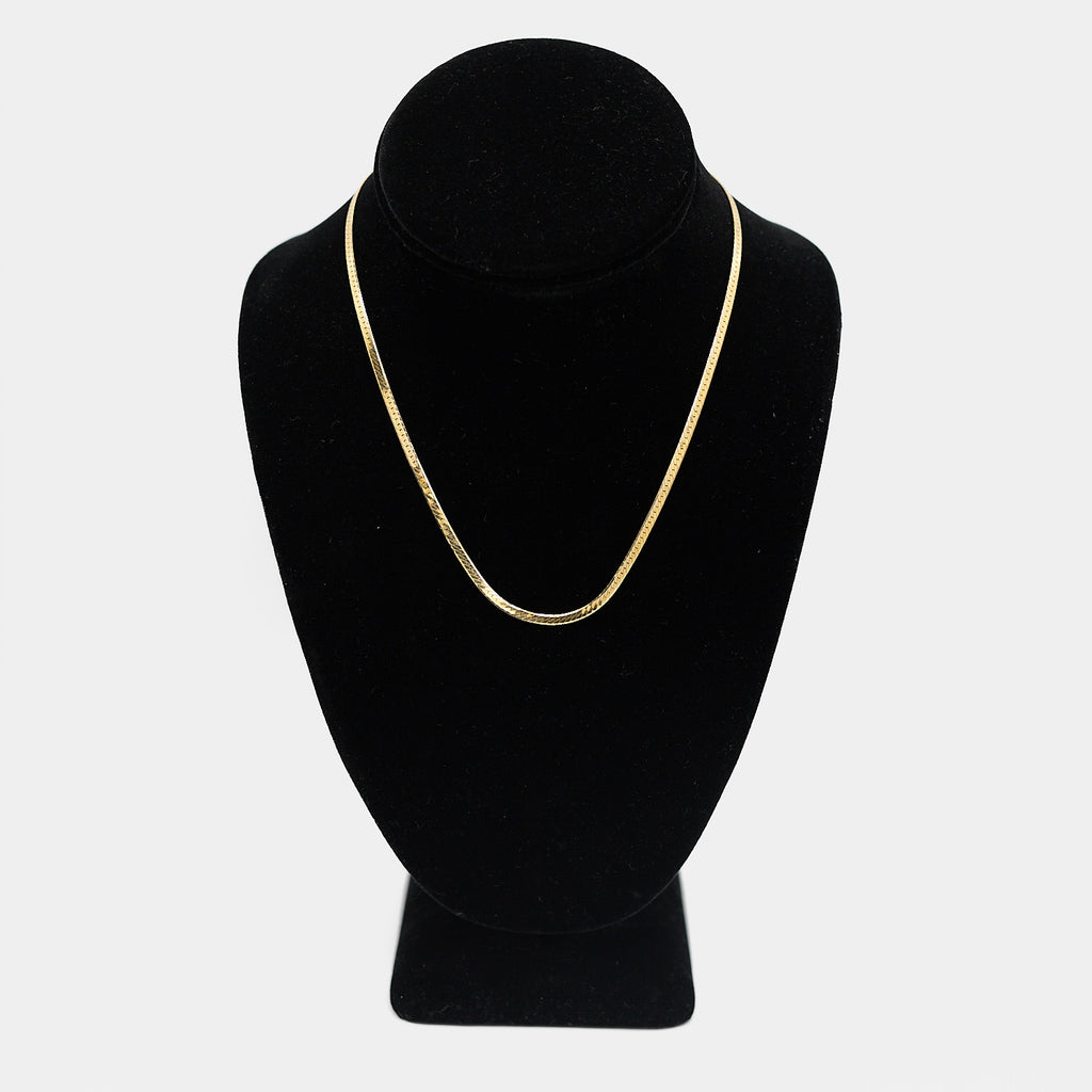 Verified pre-owned 14K yellow gold herringbone chain, 16.5 inches long, displayed on a black mannequin to show its fluid, flat-lay drape