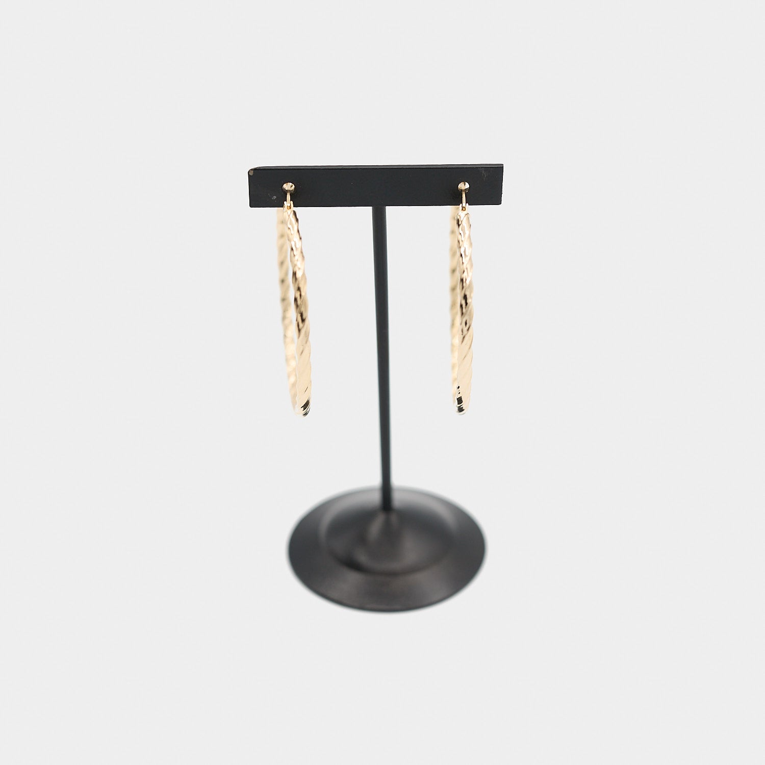 Verified pre-owned 14K yellow gold twist hoop earrings, front-facing view showcasing the elegant spiral texture and polished gold finish