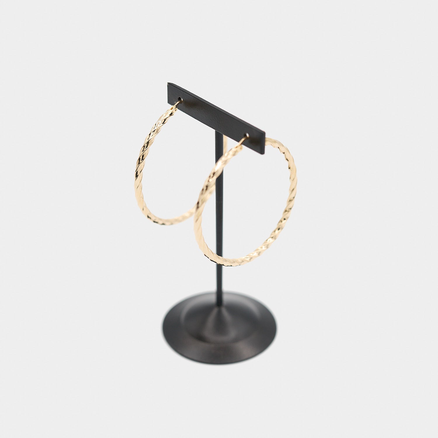 Three-quarter view of the 14K yellow gold twist hoop earring set, highlighting the spiral profile and 4.82 gram total weight.