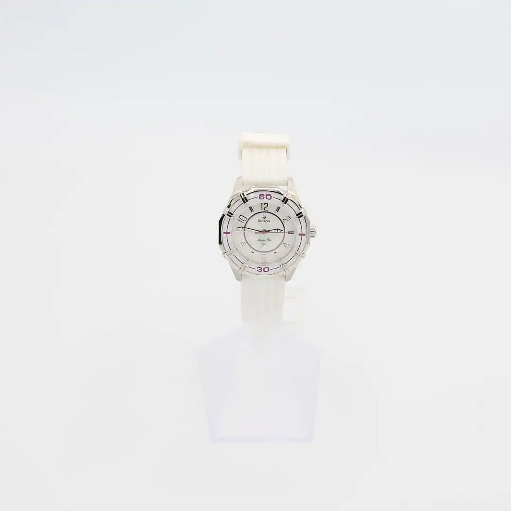 Verified pre-owned Bulova Marine Star 36mm quartz watch with white rubber band, showing iridescent dial and purple bezel accents.