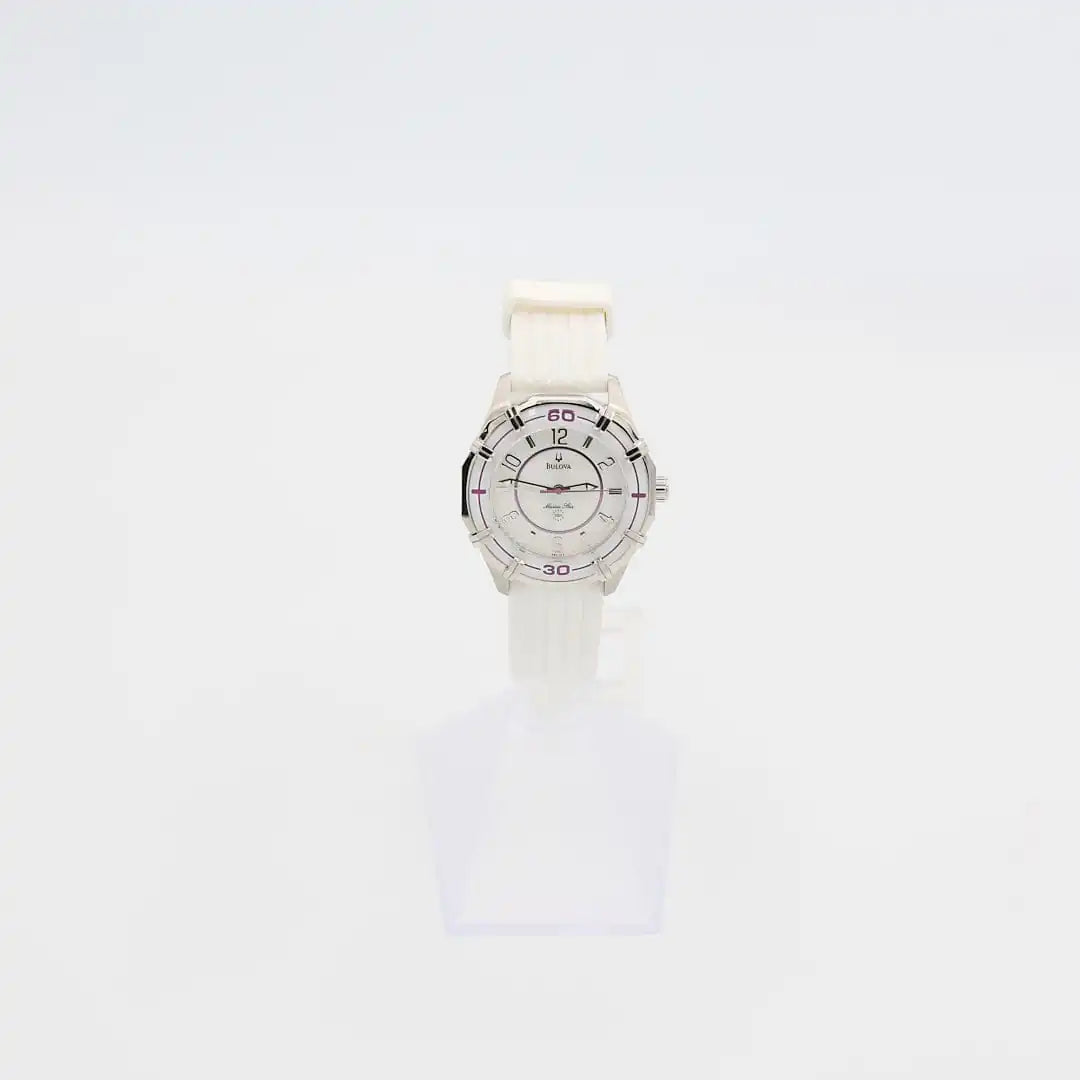 Verified pre-owned Bulova Marine Star 36mm quartz watch with white rubber band, showing iridescent dial and purple bezel accents.