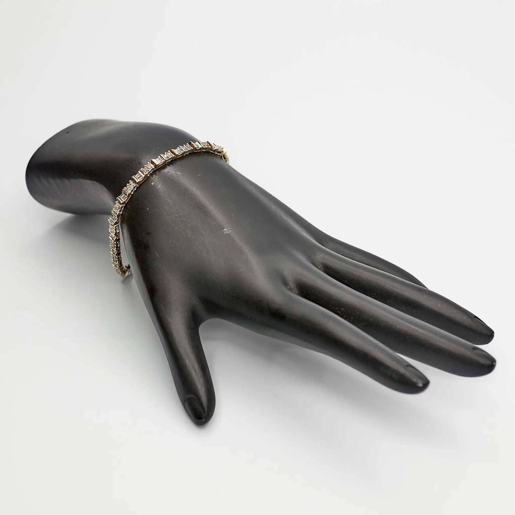 Verified Dual Tone 10K gold diamond tennis bracelet, 7 inches, styled on a mannequin to showcase the two-tone color contrast.