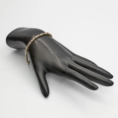 Verified Dual Tone 10K gold diamond tennis bracelet, 7 inches, styled on a mannequin to showcase the two-tone color contrast.