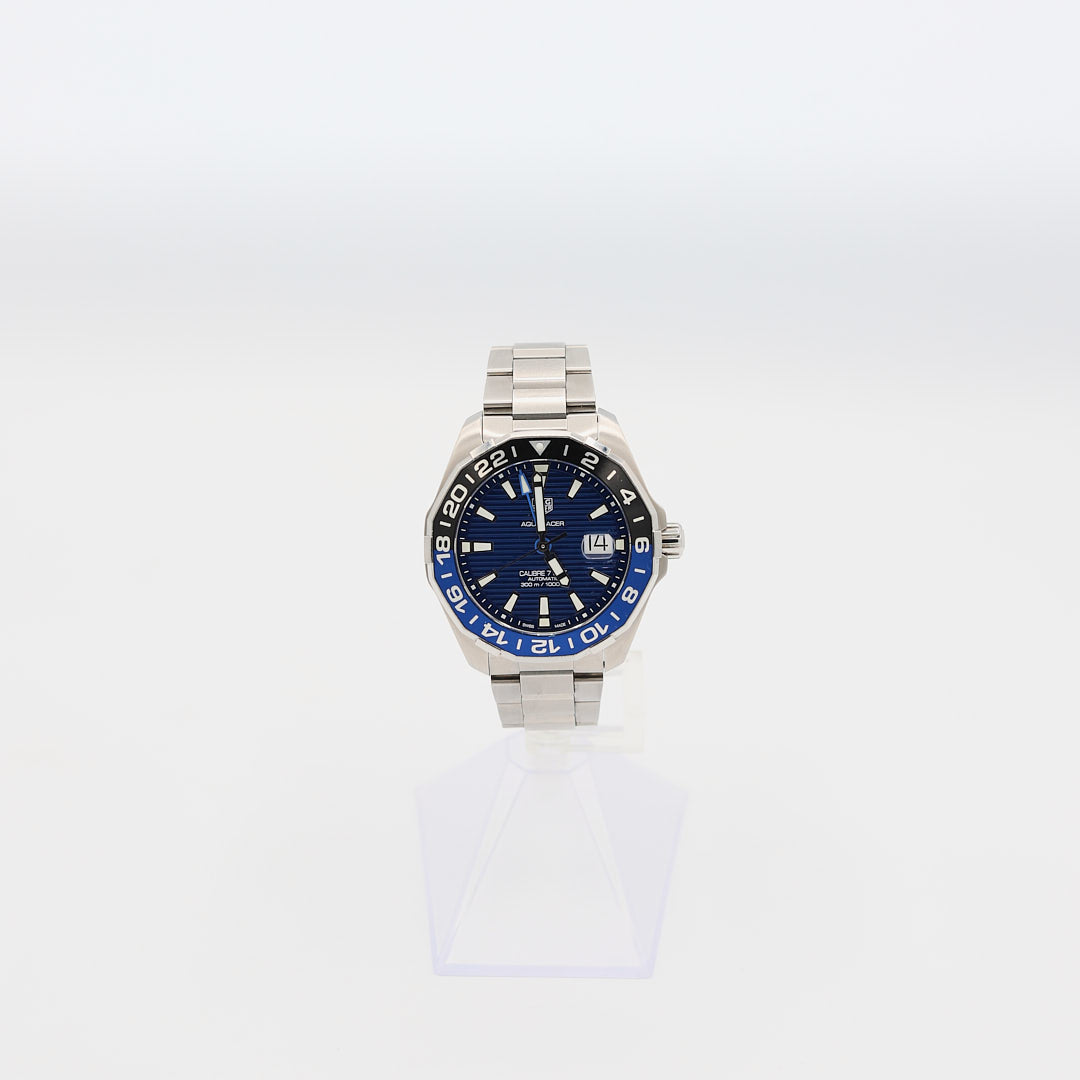 Verified pre-owned TAG Heuer Aquaracer 43mm automatic watch, showcasing the dial and glow-in-the-dark hour markers.