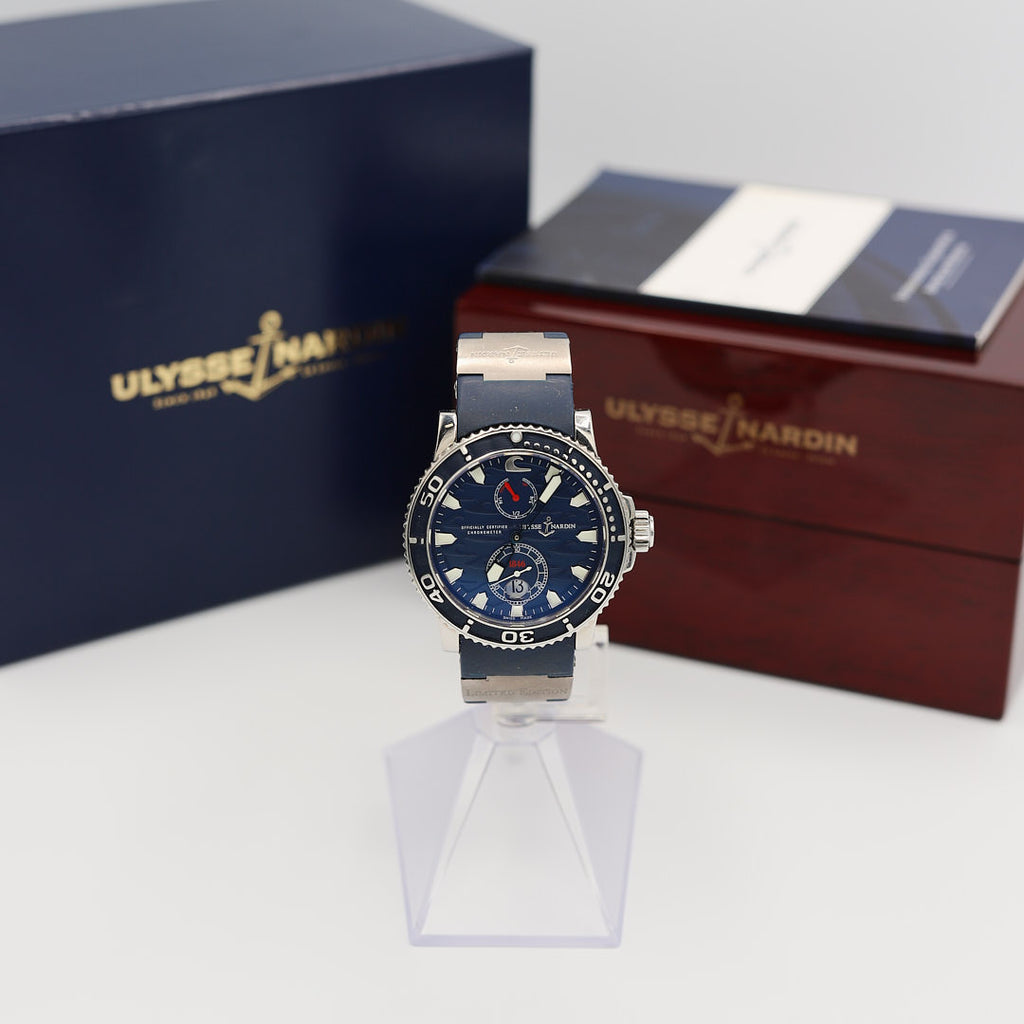 Front view of the Ulysse Nardin Maxi Marine Diver Blue Surf watch, displayed alongside the original box, instruction manual, and papers.